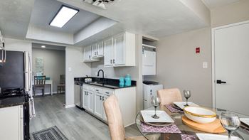 A kitchen and dining room with a table and chairs