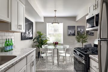 Durham apartment for rent - A modern kitchen with a dining table and chairs.