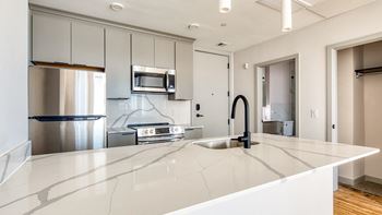 Quartz counter tops and backsplash in kitchen