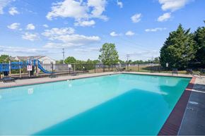 Richmond apartment for rent - A large outdoor swimming pool with a slide in the background.