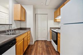 Richmond apartment for rent - A kitchen with wooden cabinets and a white refrigerator.