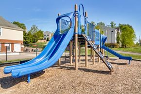 Richmond apartment for rent - A blue slide in a playground with a wooden structure.