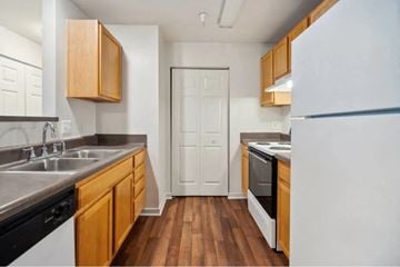 Richmond apartment for rent - A kitchen with wooden cabinets and a white refrigerator.