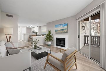 Raleigh apartment for rent - A modern living room with a fireplace and a painting on the wall.