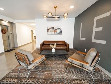 Provo apartment for rent - A living room with a brown couch and two chairs.