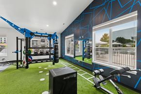 Post Falls apartment for rent - A gym with a blue and black color scheme and various exercise equipment.