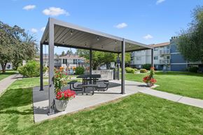Spokane Valley apartment for rent - A picnic area with a table and chairs under a canopy.