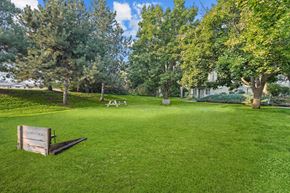 Boise apartment for rent - A park with a bench and trees.