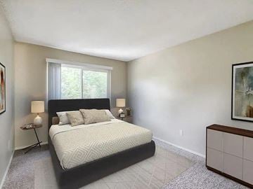 Reno apartment for rent - A bedroom with a large bed and a window.