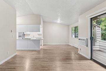 Spokane Valley apartment for rent - A kitchen with white cabinets and a wooden floor.