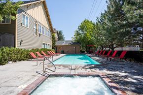 Reno apartment for rent - Swimming Pool with red chairs around at The Village at Idlewild Park, Nevada, 89509
