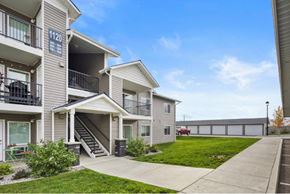 Post Falls apartment for rent - Apartment building with the number 1120 on the front at Woodland Meadows Apartments, Post Falls