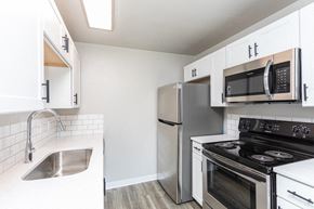 Boise apartment for rent - A kitchen with a stove, refrigerator, and microwave.