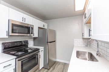 Boise apartment for rent - A kitchen with white cabinets and stainless steel appliances.