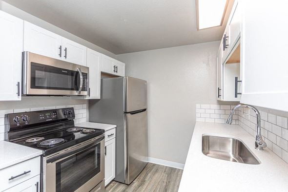Boise apartment for rent - A kitchen with white cabinets and stainless steel appliances.