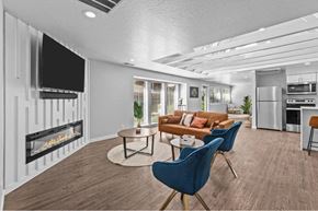 Boise apartment for rent - A modern living room with a fireplace and a television.