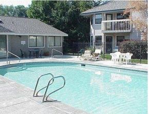 Boise apartment for rent - A small pool with a diving board in front of a house.