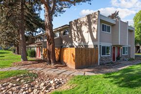 Boise apartment for rent - A house with a red door and a brown fence.