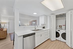 Boise apartment for rent - A modern kitchen with white cabinets and appliances.