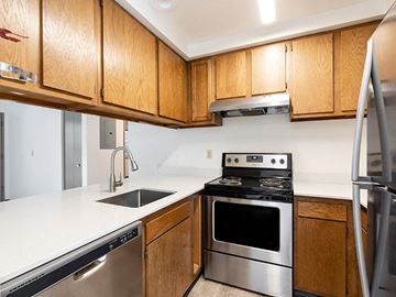 Bozeman apartment for rent - A kitchen with wooden cabinets and stainless steel appliances.