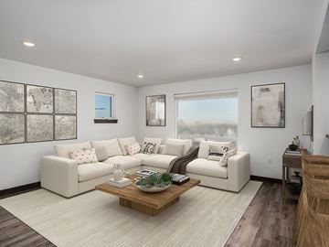 Bozeman apartment for rent - A living room with a white couch, a coffee table, and a painting on the wall.