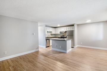 Fort Collins apartment for rent - A kitchen with a refrigerator, cabinets, and a countertop.