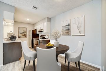 San Antonio apartment for rent - A dining room with a table set for two and a kitchen area in the background.