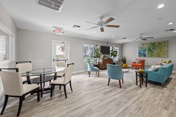 Universal City apartment for rent - A living room with a glass table and chairs.