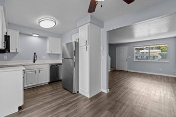 Boise apartment for rent - A kitchen with white cabinets and a refrigerator.