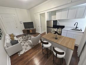 Detroit apartment for rent - A kitchen with a bar stool and a counter.