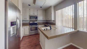 Vacaville apartment for rent - A kitchen with a refrigerator, oven, and microwave.