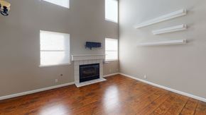 Vacaville apartment for rent - A living room with a fireplace and wooden floors.