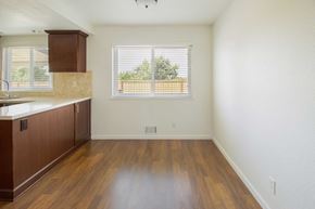 Pittsburg apartment for rent - A kitchen with wooden floors and white walls.