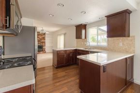 Pittsburg apartment for rent - A kitchen with brown cabinets and a stove top oven.