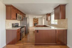 Pittsburg apartment for rent - A kitchen with brown cabinets and a white countertop.
