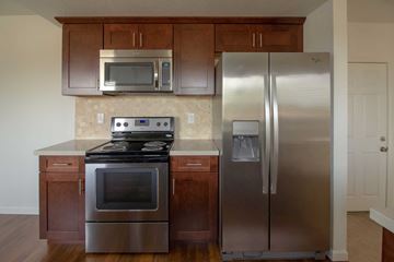 Pittsburg apartment for rent - A kitchen with a stainless steel refrigerator and oven.