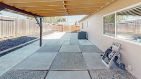 Vacaville apartment for rent - A concrete patio with a grey tile border and a concrete walkway.