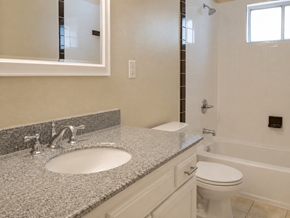 Pittsburg apartment for rent - A bathroom with a granite countertop and white fixtures.