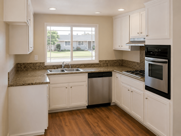 Pittsburg apartment for rent - A kitchen with white cabinets and a granite countertop.