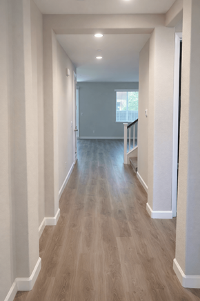 Chico house for rent - A long hallway with wood floors and white walls.