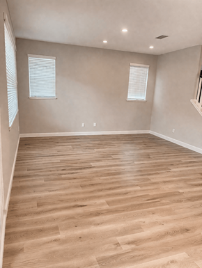 Chico house for rent - A room with wooden flooring and two windows.