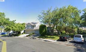 Pittsburg apartment for rent - A street view of a residential area with houses and parked cars.