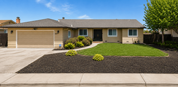 Pittsburg apartment for rent - A house with a brown garage door and a black gravel driveway.