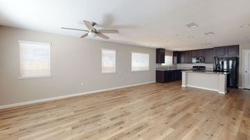 Pittsburg apartment for rent - A spacious room with wooden flooring and a ceiling fan.