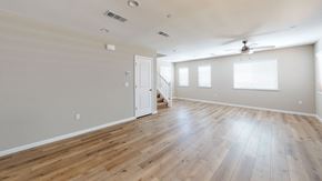 Pittsburg apartment for rent - A room with wooden floors and a ceiling fan.