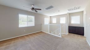 Pittsburg apartment for rent - A spacious room with a fan, carpeted floor, and a window with blinds.