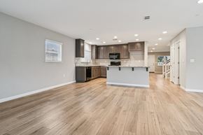 Bay Point apartment for rent - A kitchen with wooden floors and a white wall.