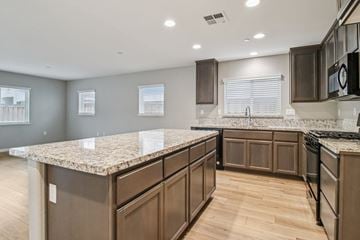 Bay Point apartment for rent - A kitchen with brown cabinets and a granite countertop.