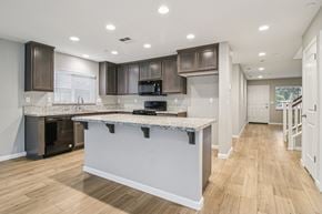 Bay Point apartment for rent - A modern kitchen with a granite countertop and wooden cabinets.