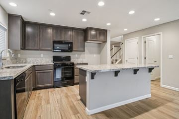 Bay Point apartment for rent - A kitchen with a granite countertop and wooden cabinets.